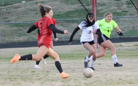 Press photo/Will Woolever.  Junior Teah Phillips catches East Henderson’s goalkeeper out of her net at the Panther Pit March 18. 