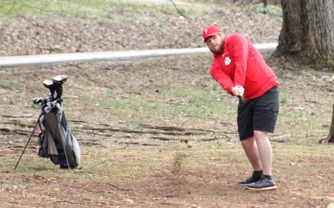 Press photo/Will Woolever. Senior Cooper Guffie chips out of the rough at the Franklin Golf Course versus Smoky Mountain Feb. 28.