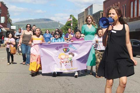 Press photo/Thomas Sherrill - Led by Gracie Parker, attendees of the second annual Youth Mental Health Rally in downtown Franklin march down Main Street. More photos from the rally will be posted on The Franklin Press Facebook page.