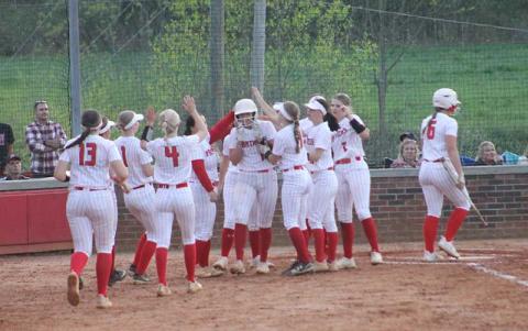 Press photo/Will Woolever - Sophomore Kendall Rumans (center, wearing batting helmet) is mobbed by teammates after a solo home run versus Pisgah April 19. 