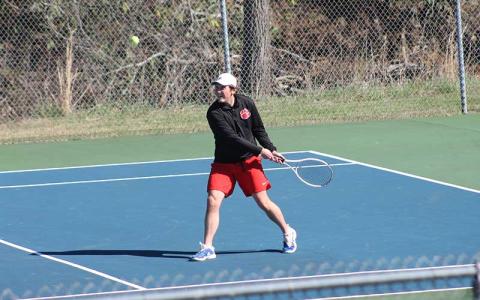 Junior Eli Adams backhands a ball versus Pisgah at the Macon County Rec Park March 28 (Press photo/Will Woolever).