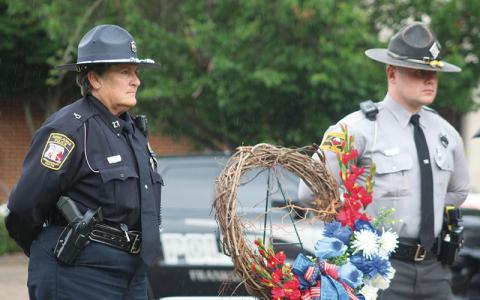 Press photo/Thomas Sherrill. Highlands Police Capt. Leah McCall and N.C. State Highway Patrol Trooper H.W. Gass lay a wreath at the Macon County Courthouse during the Fallen Officers Memorial on Friday, May 17.