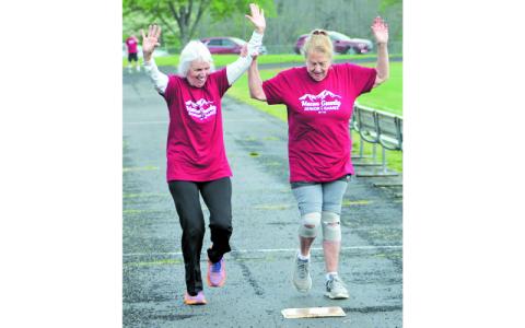 Press photo/Will Woolever. Jo Provost (left) and Lisa McDowell run to a photo finish in the 100-meter dash at the Macon County Senior Games recently. “As long as we’re still moving around and having fun,” said Provost.