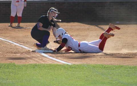 Senior Olivia Birchard slides back into first base versus North Henderson April 23. (Press photo/Will Woolever)