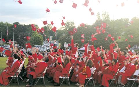Press photos/Thomas Sherrill.  Franklin High School graduates toss their caps at the conclusion of the commencement ceremony on May 30. 