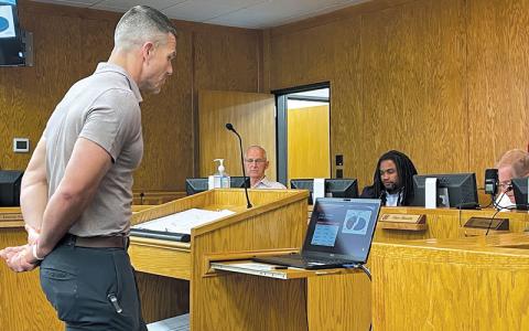 Press photo/Mia Overton. County Manager Derek Roland presents the proposed 2024-25 budget at a meeting on May 21. Also pictured are commissioners Paul Higdon, Danny Antoine and Chair Gary Shields.