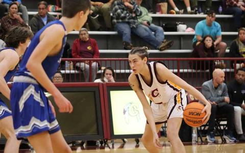 Photo courtesy of Brooklyn Brown/Cherokee One Feather - Rising junior Jack Teesateskie stares down defenders in Cherokee’s home playoff game versus Christ the King last February. Teesateskie transferred to Franklin this summer after averaging 17.3 points per game for the Braves his sophomore year. 