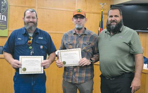 Press photo/Mia Overton - During the July 1 Franklin Town Council meeting, Public Works Director Bill Deal (right) recognized his staff members who recently completed certification training. Jon Sanders (left) received Collections 1 certification and Rusty Cortopassi completed Collections 2 training. Both are equipment operators with the public works department. Water treatment plant operator Korah Shepherd (not pictured) received B Certification.
