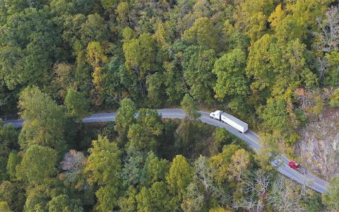 Photo/Eric Haggart. An aerial view showing a transfer truck traveling through the Cullasaja Gorge.