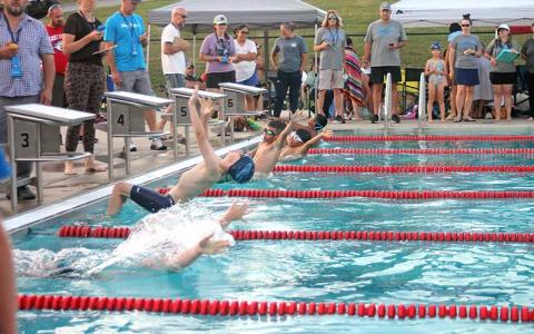 Press photo/Will Woolever - Swimmers leave their starting blocks for the 9-10 boys 50-yard backstroke at the Macon County Rec Park July 2.