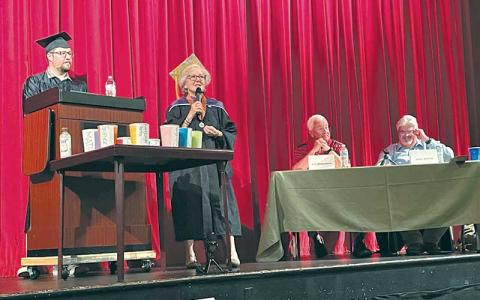 (From left) Matt Holland, chair of the Macon County Young Progressive Voters, and Betsy Baste, third vice chair of the Macon County Democratic Party speak at the beginning of the school board forum on Aug. 25 with candidates Jim Breedlove and John deVille.