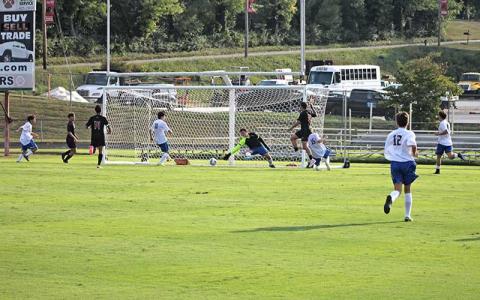Press photo/Will Woolever - Junior forward Greg Karcher (wearing black) beats Highlands goalkeeper Chase Kenter in Franklin’s 11-2 season-opening rout Aug. 12. 