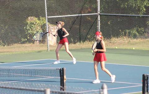 Abigail Angel forehands a ball versus Pisgah Aug. 26 while fellow senior Caroline Deal guards the net. 