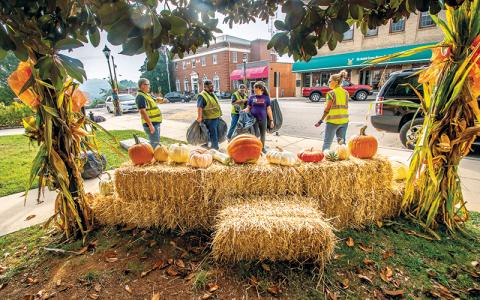 Photo/Bob Scott - Workers from the Town of Franklin and LBJ Job Corps decorating for fall on Main Street.