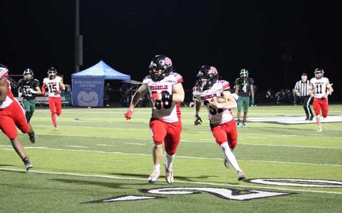 Press photo/Vickie Carpenter - Junior Aiden Pitts (right) returns his second-quarter interception for a touchdown with help from Addix Sutton in Franklin’s 48-8 win at East Henderson Sept. 20.