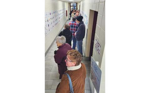 Press photos/Thomas Sherrill - People stand in line while waiting to vote on the first day of early voting, Oct. 17.
