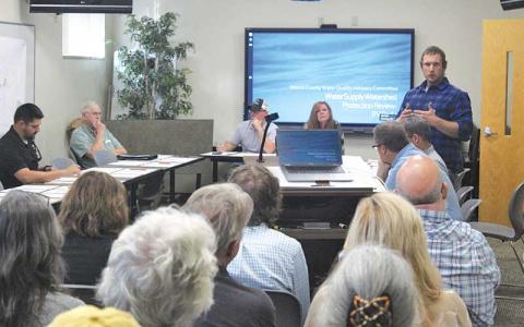 Press photo/Thomas Sherrill - Macon County Commissioner Josh Young (standing) speaks at the Oct. 3 Macon County Planning Board meeting.