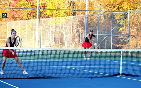 Press photo/Will Woolever - Senior Caroline Deal (left) guards the net while fellow senior Maci Stork serves versus South Rowan Oct. 23. 