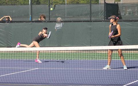 Press photo/Will Woolever - Senior Abigail Angel (left) hits a difficult backhand while her doubles partner Kate Phillips guards the net Oct. 9.