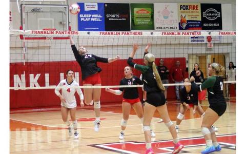 Press file photo - Freshman Ella Raby lifts a ball over the net versus East Henderson on Tom Raby Court Sept. 17. 