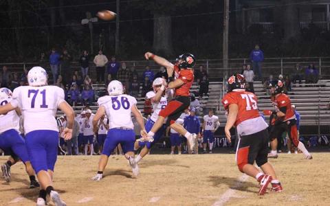 Press photo/Will Woolever - Sophomore quarterback Anderson Terrell takes a hit but delivers the throw versus West Henderson Oct. 25. 