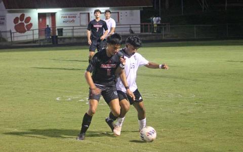 Press photo/Will Woolever - Senior Miguel Cruz fights for possession in Franklin’s stunning come-from-behind win over East Henderson Oct. 9.