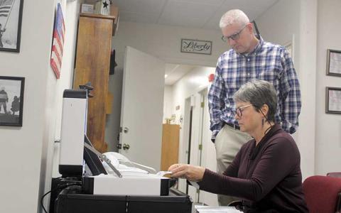 Press photo/Thomas Sherrill - Macon County Board of Election members Lynne Garrison and John VanHook feed absentee votes into a machine that tallies the totals during canvass on Friday, Nov. 15. Approved absentee and provisional ballots were added to the totals and the board made the 2024 General Election official.