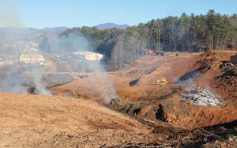 Press photo/Thomas Sherrill - Carroll Daniel has started site preparation for the new Franklin High School. In the weeks leading up to Christmas the trees along the Frogtown property were cleared and burned. The new school will sit on the hill above, at the former practice field site.