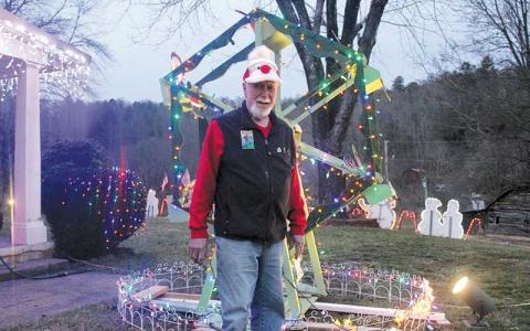 Press photo/Thomas Sherrill - Fred Haller with one of the light displays at his Rabbit Creek Road home in Franklin. His displays are one-of-a-kind as he builds them himself.