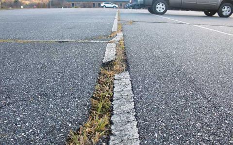 Press photo/Thomas Sherrill - The large cracks in the Mountain View Intermediate main parking lot are a constant trip hazard and a top priority for repaving.