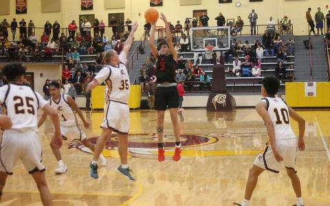 Press photo/Will Woolever - Junior Jack Teesateskie attempts a 3-pointer versus his former team at Cherokee Nov. 26. 