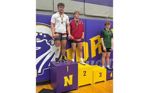 Photo courtesy of Amiee Bailey - Freshman Garrett Young (center) is pictured on the podium after placing second in the 215-lb. weight class at the North Knight Invitational at North Henderson Nov. 27.