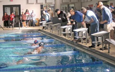 Press photo/Will Woolever - Junior Jonah Brant (center) races to a photo finish in the men’s 100-yard breaststroke at the Mountain Seven Conference Championship meet Jan. 18.