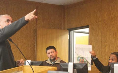 Press photo/Thomas Sherrill - Macon County Parks and Recreation Director Seth Adams (left) points out the new concept for Phase 1A of the Macon County Recreation Park Master Plan on a screen while Commissioner Danny Antoine shows an original concept of the same phase, which had been changed to his chagrin. Also pictured is Commissioner Barry Breeden.