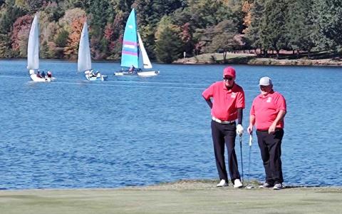 Photo submitted - Golfers Jason Hedrick (left) and Eric Hall line up a putt in a Special Olympics North Carolina Golf Tour event at Oak Hollow Golf Course in High Point last October. 
