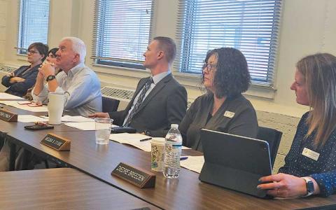 Press photo/Thomas Sherrill - The Macon County Schools Board of Education and Superintendent Josh Lynch watch and listen to a presentation at a Feb. 4 special morning meeting at the MCS Central Office.