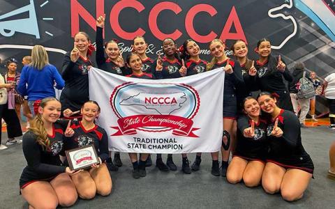 Photo courtesy of Lynn Baker - Panther cheer and dance shows off their Traditional State Champion banner after the N.C. Cheerleading Coaches’ Association state competition at Davie County High School Feb. 1. 