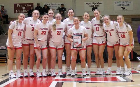 Senior guard McKenna Plemmons (holding plaque) is honored for her FHS-record eight 3-pointers at West Henderson Feb. 7, which led her team to a 64-59 win. Plemmons is pictured with her teammates on Tom Raby Court before tipoff of Franklin’s first-round conference tournament win over North Henderson Feb. 14. (Press photo/Will Woolever)
