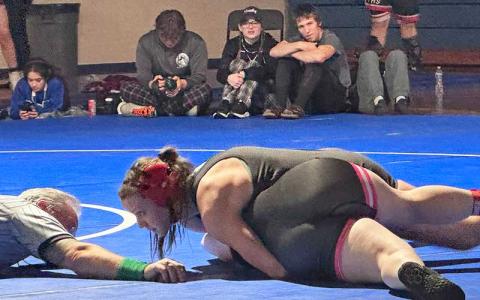 Photo courtesy of Amiee Bailey - Mountain Seven Champion Carrie Holland battles a wrestler at the conference tournament at West Henderson Jan. 25. 