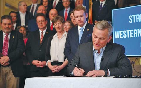 Photo/NC Governor’s Office - Gov. Josh Stein signs the Disaster Recovery Act of 2025 Part 1 on March 19. Looking on are members of the N.C. General Assembly, including Sen. Kevin Corbin (second from left) of Franklin, the WNC Advisory Committee, law enforcement officials and agriculture leaders.