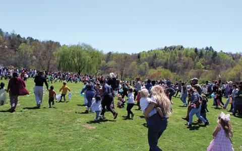 Photo/Shelby Powell - Children and their families rush the field at the fifth annual Easter Egg Drop at South Macon Elementary.