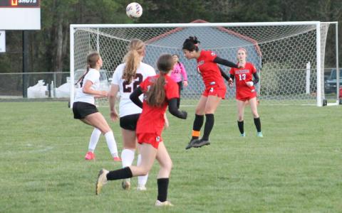Press photo/Will Woolever. Senior Daisy Altamirano heads a ball versus Pisgah March 24. 