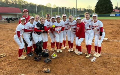 Press photo/Will Woolever - Junior Kendall Rumans (center, holding plaque) is pictured with her softball teammates after breaking the program’s career home runs record versus East Henderson April 8. 