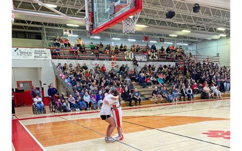 White Team player Abby Brogden celebrates with her partner, McKayla Sanders, after making a shot in the sixth annual UNIFY game March 27. (Press file photo)