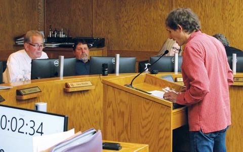 Press photo/Shelby Powell - Local biologist Jason Love (right) discusses unnecessary damage to local waterways caused by U.S. Army Corps of Engineers debris removal efforts. Listening are County Commissioners Gary Shields and John Shearl.
