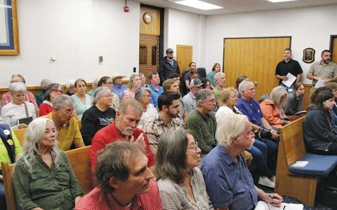 Press photo/Shelby Powell - Dozens file into the Macon County Board of Commissioners meeting chamber to show support for local waterways, the regional library system and to discuss the county’s Community Funding Pool. 