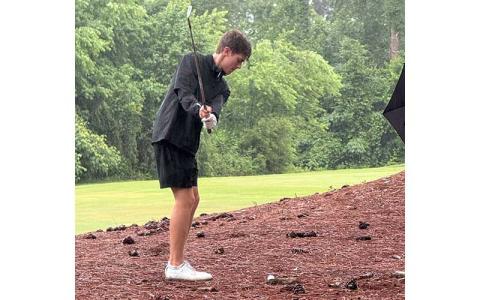 Photo courtesy of Dan Gibson - Junior Tanner Jones lines up a shot in the pouring rain at the State Men’s Golf Tournament in Fayetteville May 12. 