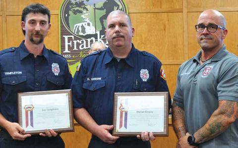 Press photo/Mia Overton - Franklin firefighters Joe Templeton and Darian Greene were presented Life Saving Awards for their actions to rescue a man from a burning structure on May 8. Chief Ben Ormond presented the awards at the June 2 Franklin Town Council meeting.