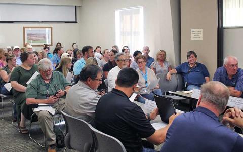 Press photos/Shelby Powell - A sizable crowd fills the Macon County Board of Health’s meeting room, where 15 community members spoke at a special meeting.