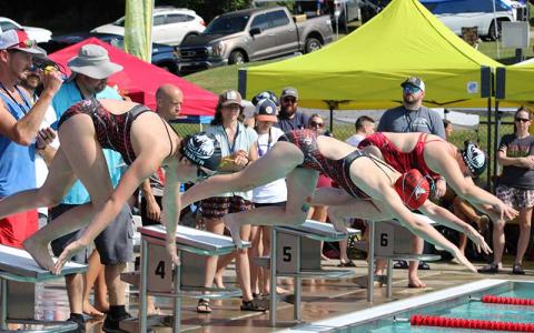 Press photo/Vickie Carpenter - FAST swimmers leave their starting blocks for the girls 15-18 100-yard freestyle at the Mountain Swim League Championship Meet July 12 at the Macon County Rec Park. 